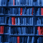 wall of blue books with banned books in red