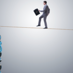 Businessman walking on tight rope