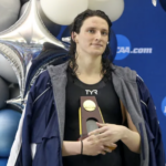 Swimmer Lia Thomas holds trophy