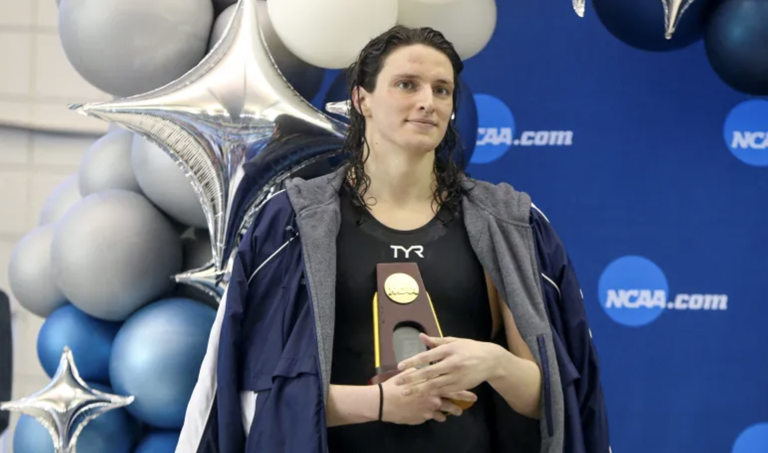 Swimmer Lia Thomas holds trophy