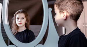 boy looks in mirror sees girl