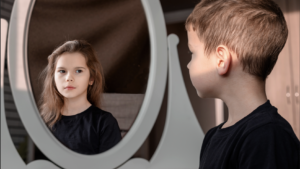 Boy looking in mirror sees girl - transgender