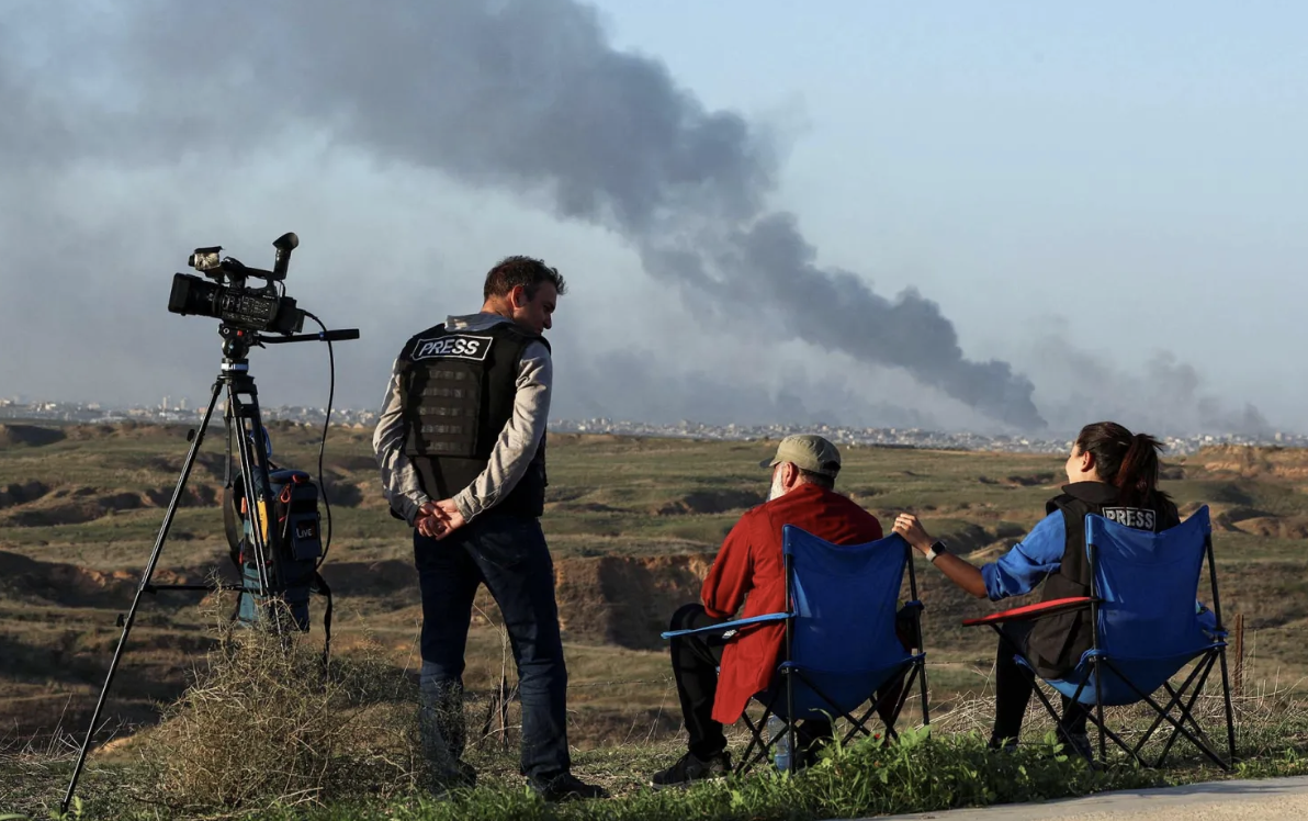 Journalists observe as smoke rises over Gaza