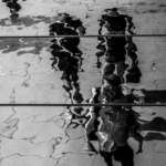 Watery b and w of people walking on a street