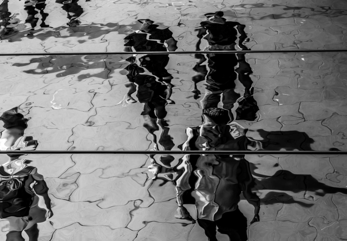 Watery b and w of people walking on a street