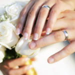 wedding - hands with rings on bouquet