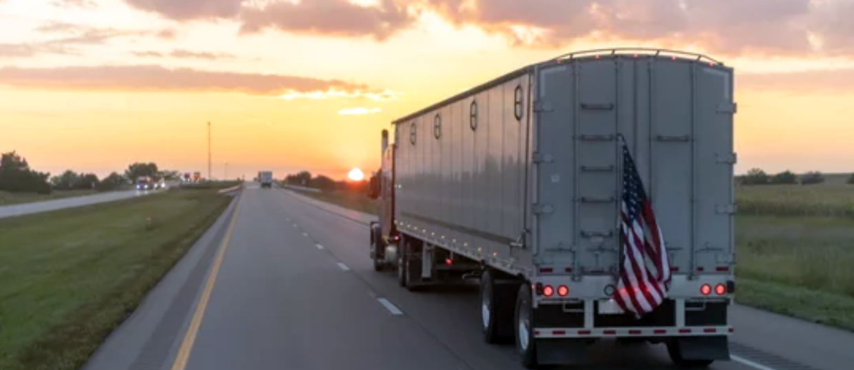 18-Wheeler at sunset with US Flag - working man.png