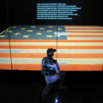 A boy views the flag known as "The Star Spangled Banner" at the Smithsonian Museum of American History in Washington,