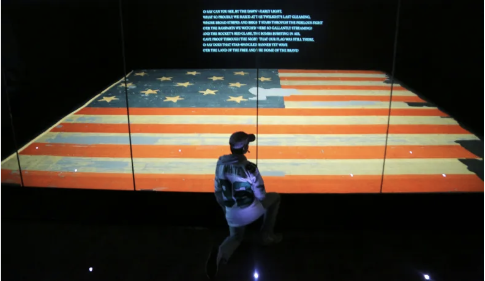 A boy views the flag known as "The Star Spangled Banner" at the Smithsonian Museum of American History in Washington,