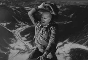 B&W of cowboy Biden riding a missile up