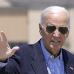 sunglass wearing Biden squints and waves