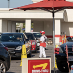 worker in a restaurant fast food drive through