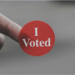 I Voted sticker on the end of a finger