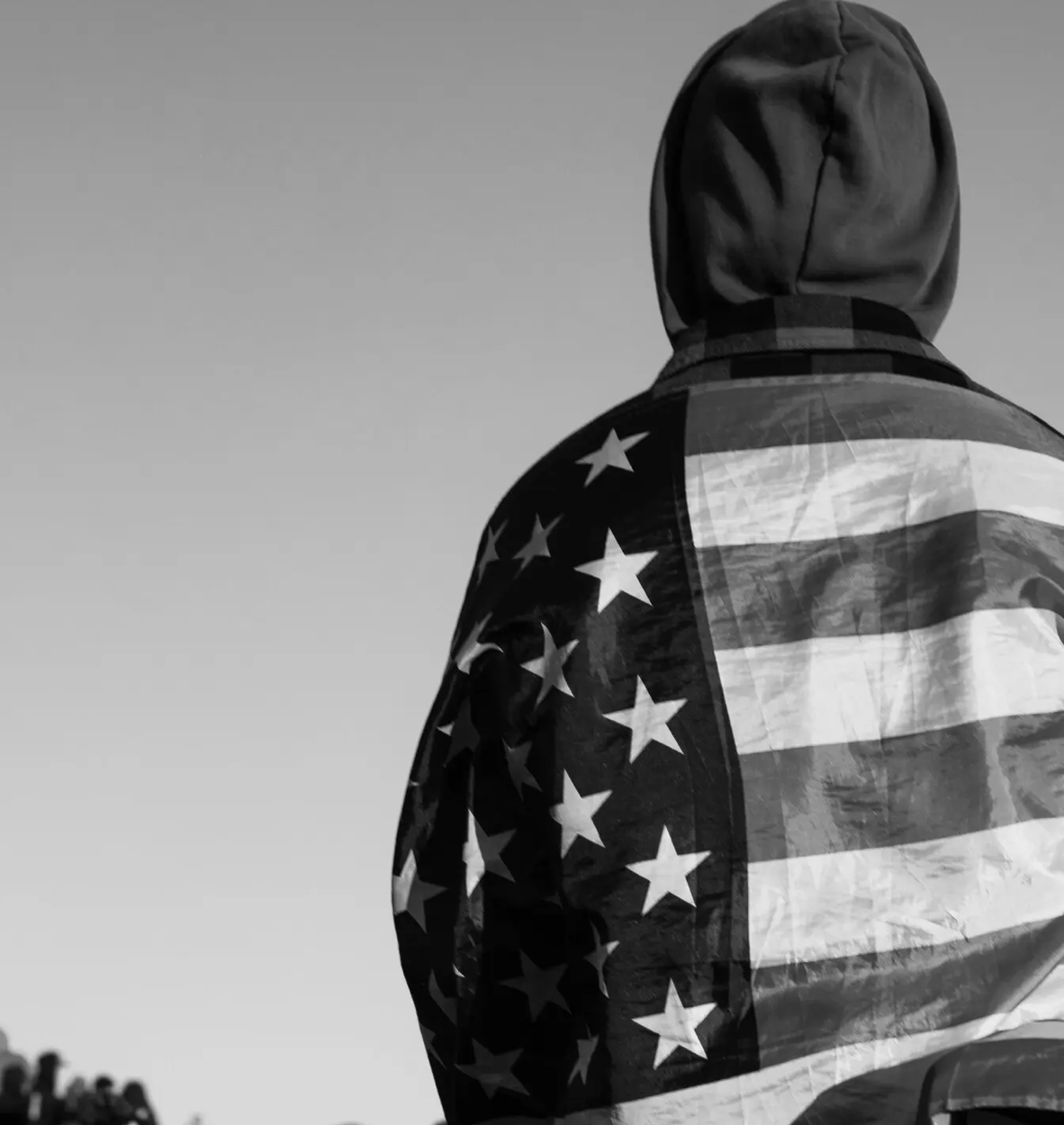 black and white - young person wearing US flag jacket