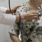 Female Dr uses stethescope on patient