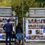 people look at posters of Israeli hostages