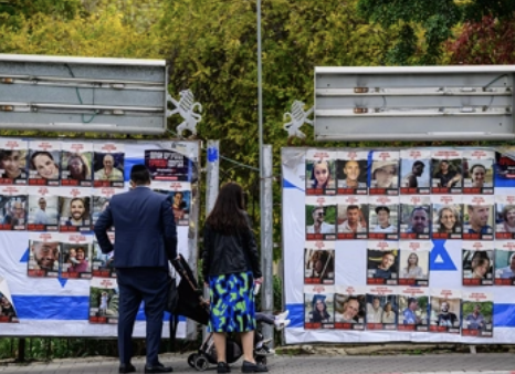 people look at posters of Israeli hostages