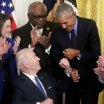 Biden Obama fist bump after signing legislation