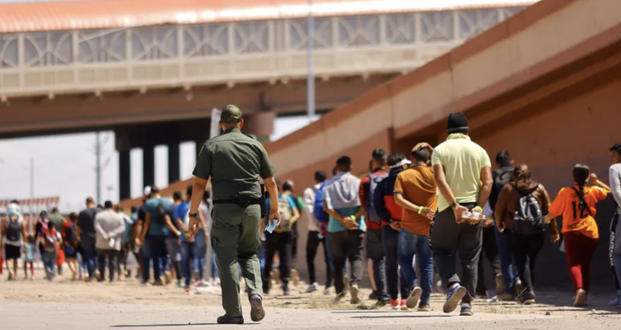 Detained Illegal immigrants with Border Patrol Officers