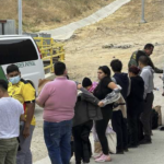 Long line of illegal immigrants with DPS at the border wall