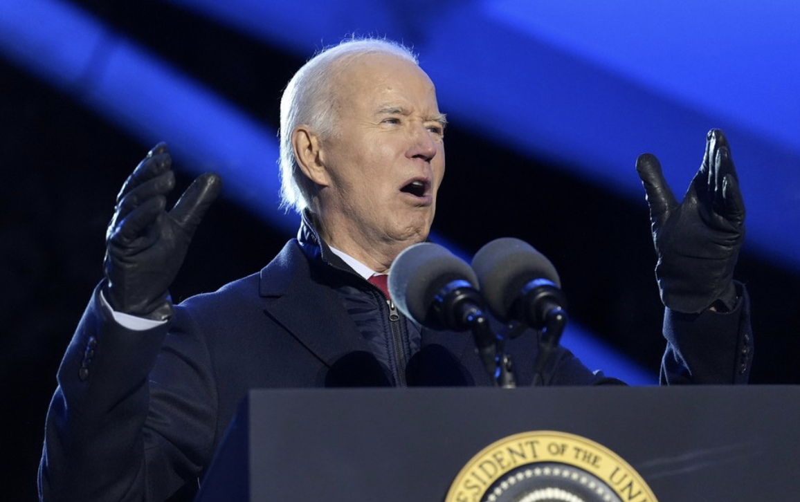 Aged Biden speaks outside in the cold