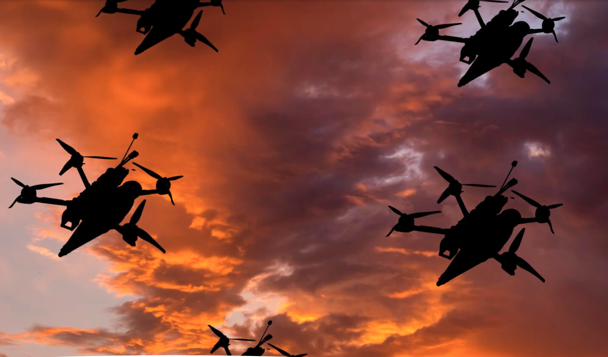 four large drones against stormy twilight sky