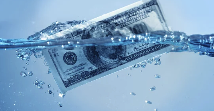 Hundred dollar bill sinking in tank of water