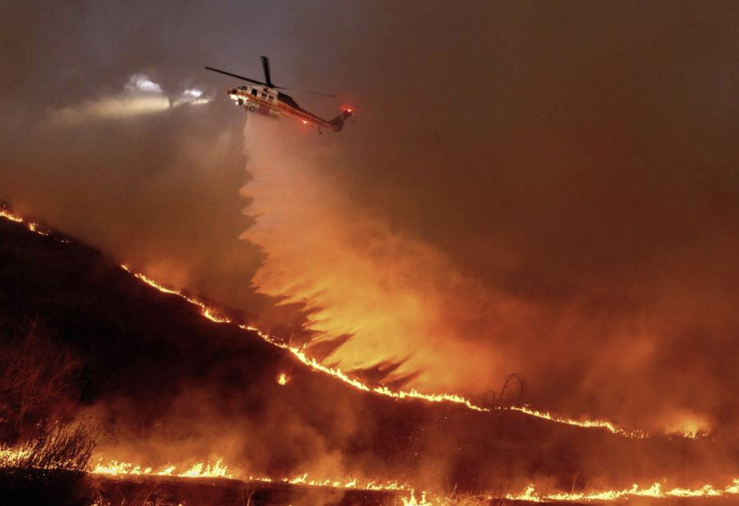 LA Fires - helicopter dumping water over flames