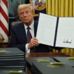 Trump holds up signed executive order