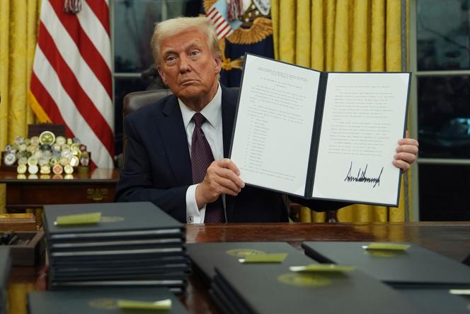 Trump holds up signed executive order