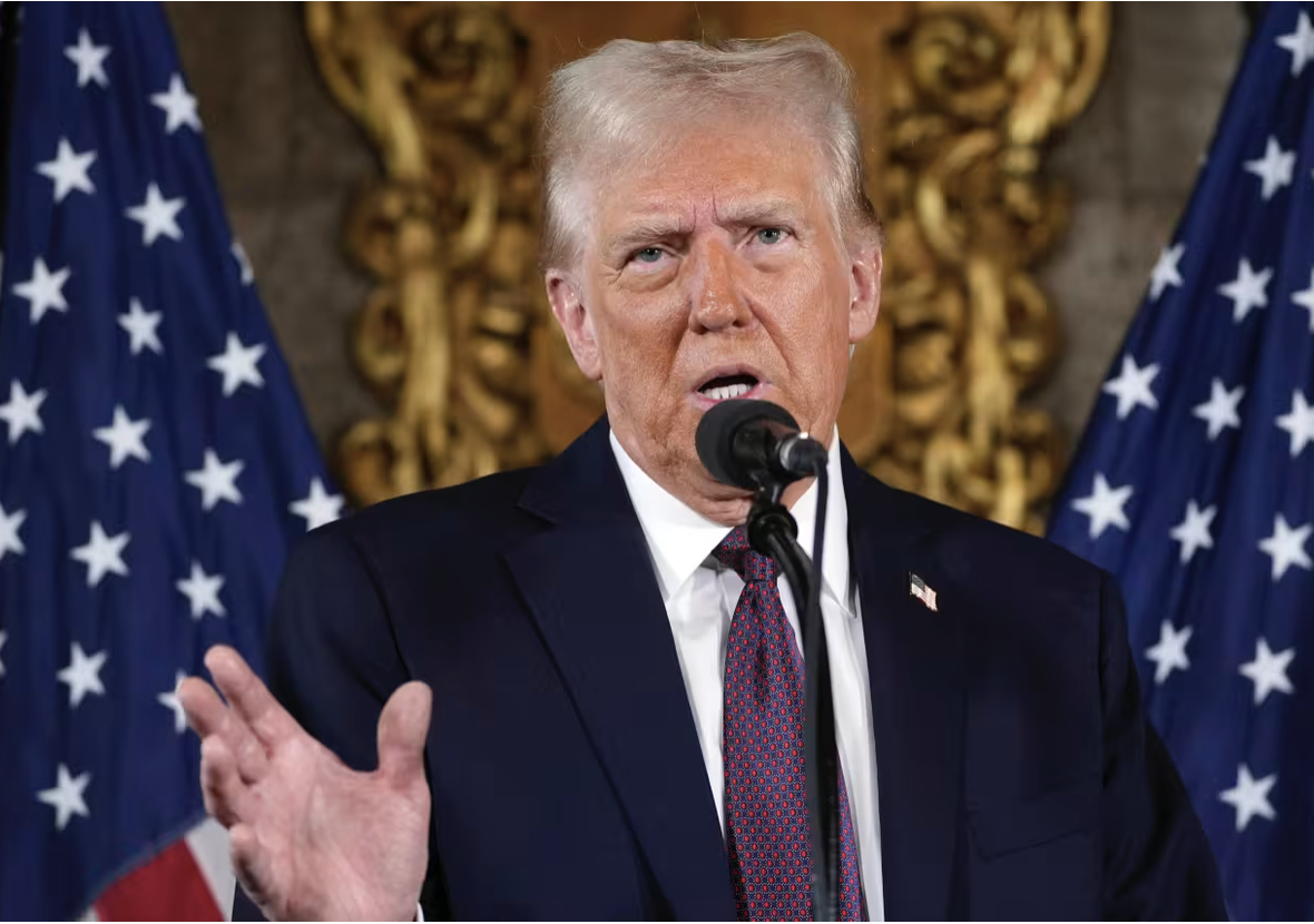 Trump speaks at a podium at Mar-a-lago