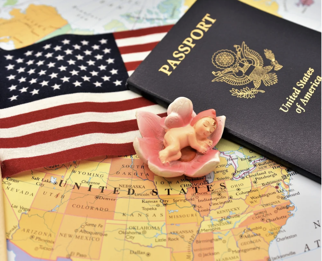 US Map, flag, passport, and small ceramic baby