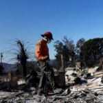 search and rescue member goes through damaged homes