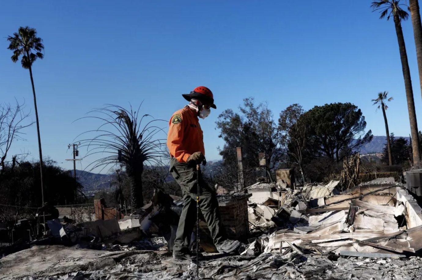 search and rescue member goes through damaged homes