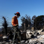 search and rescue worker goes through damaged homes