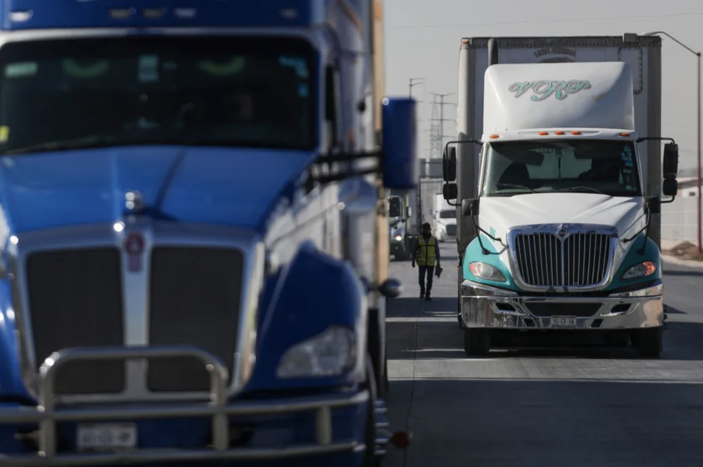 18-wheelers semi trucks waiting to unload shipping containers