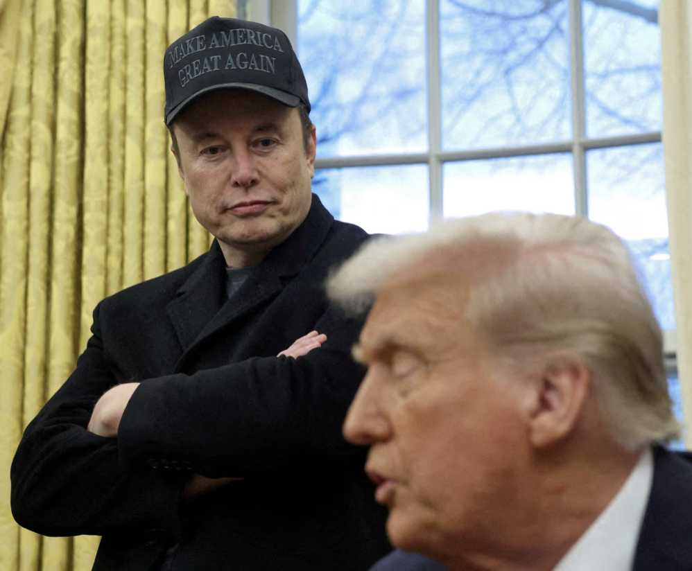 Elon Musk listens to President Donald Trump speak in the Oval Office on February 11