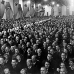 Germans crowding room in Reichenberger, listening to Joseph Goebbels speech