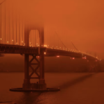 Golden Gate Bridge under a smoke-filled sky at midday