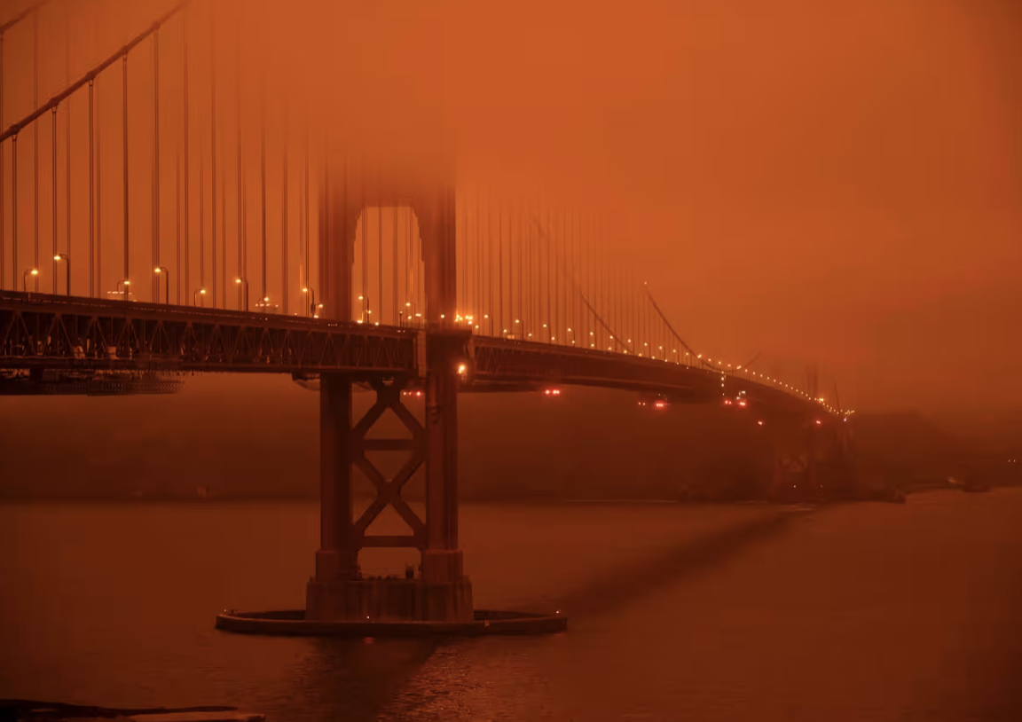 Golden Gate Bridge under a smoke-filled sky at midday