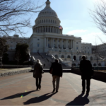 People walk toward the US Capitol