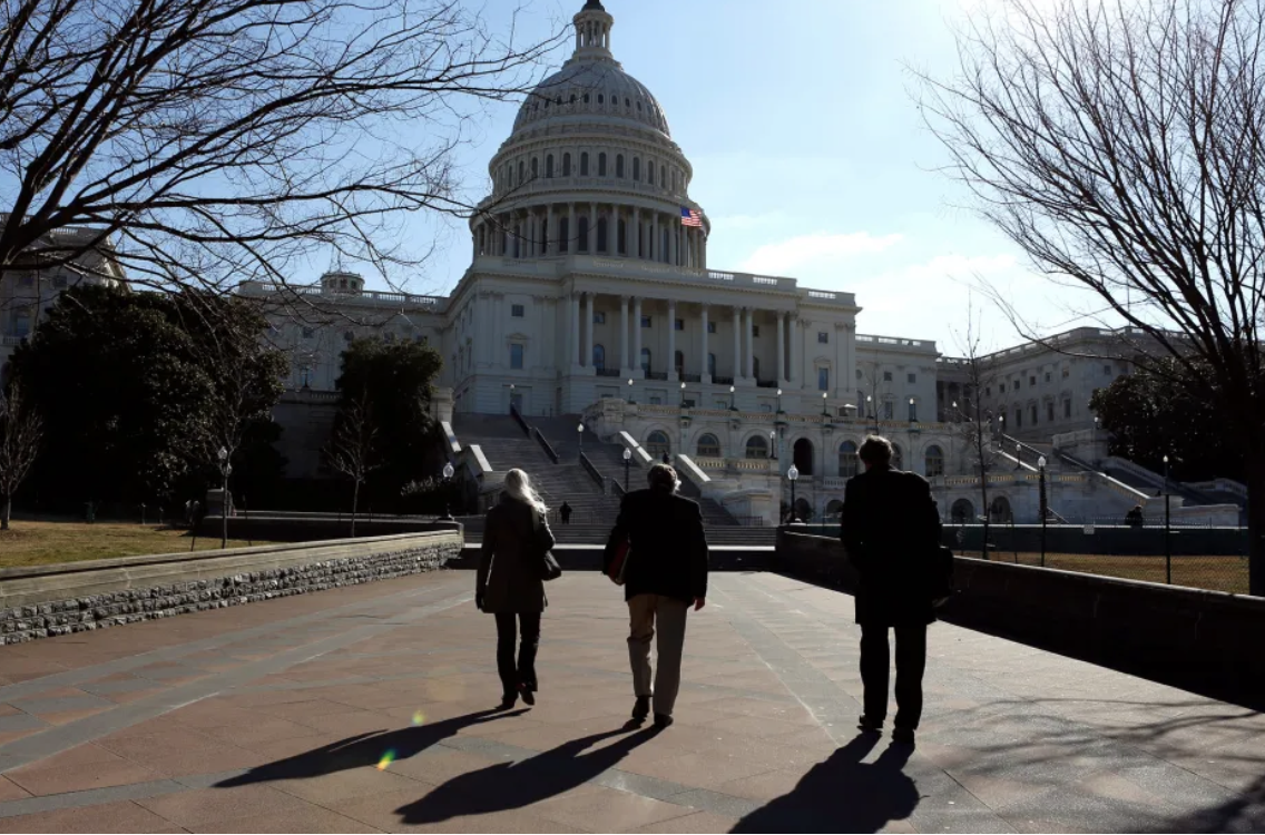 People walk toward the US Capitol