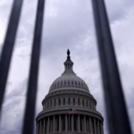 The Capitol building through bars