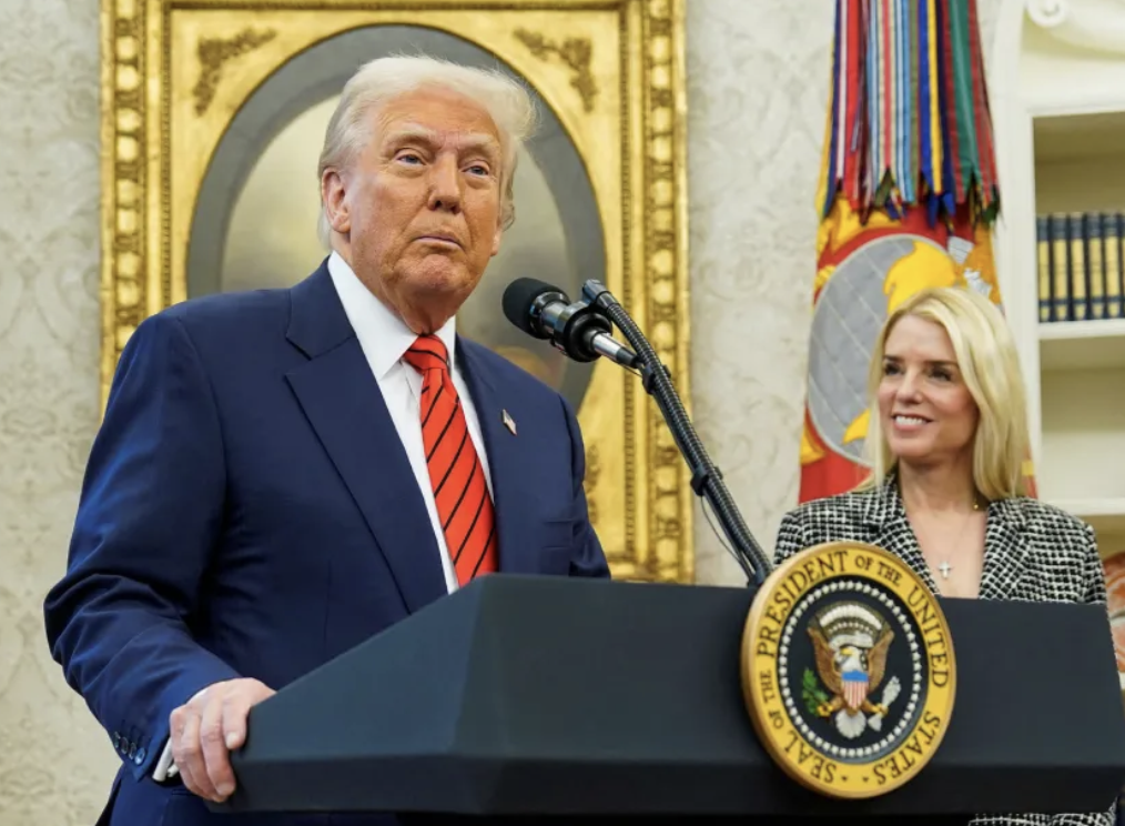 Trump speaks while Pam Bondi looks