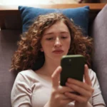Gen Z-er bored on couch with phone