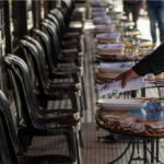 Server puts silverware at empty tables in CA