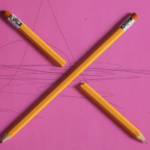 Pink Construction paper - X made of 2 pencils squiggles