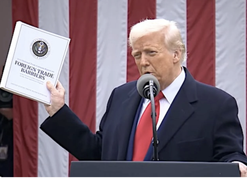 Trump holding Foreign Trade Barriers Book