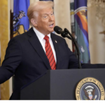 Trump speaks arms wide smiling