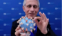 Anthony Fauci with a model of the Covid-19 virus